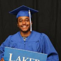 GradFest attendee holding up laker for a lifetime sign